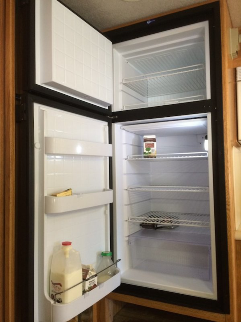 A refrigerator with the door open

Description automatically generated